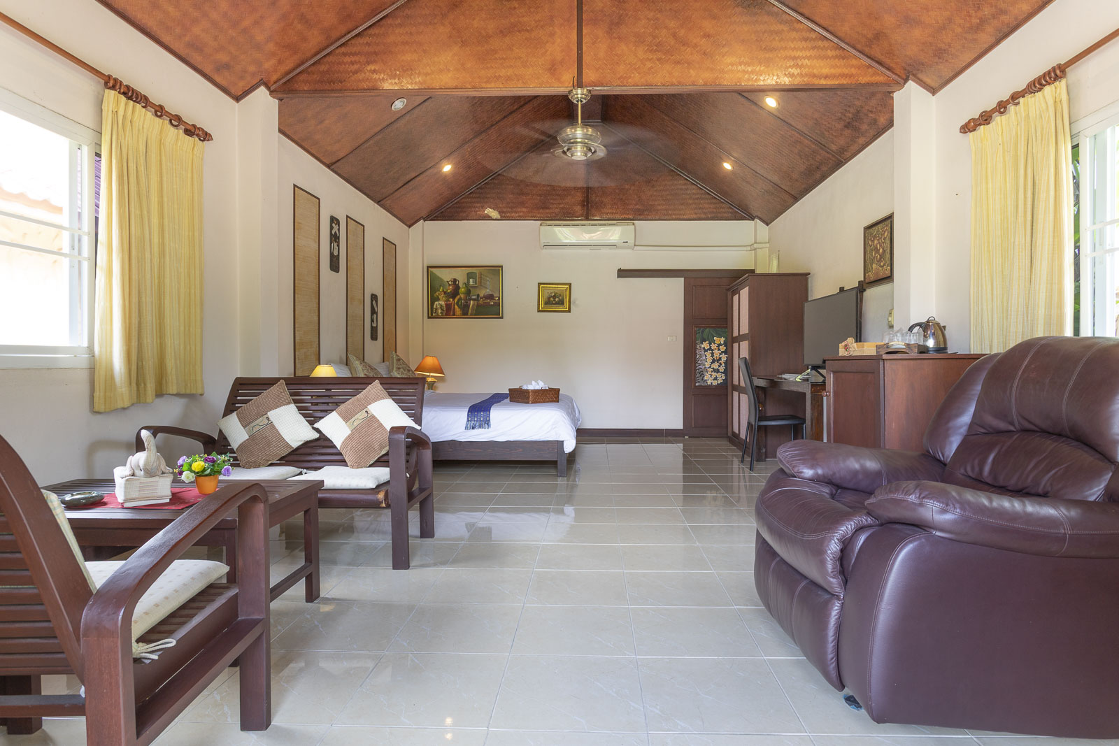 Spacious bungalow interior with seating area and bed