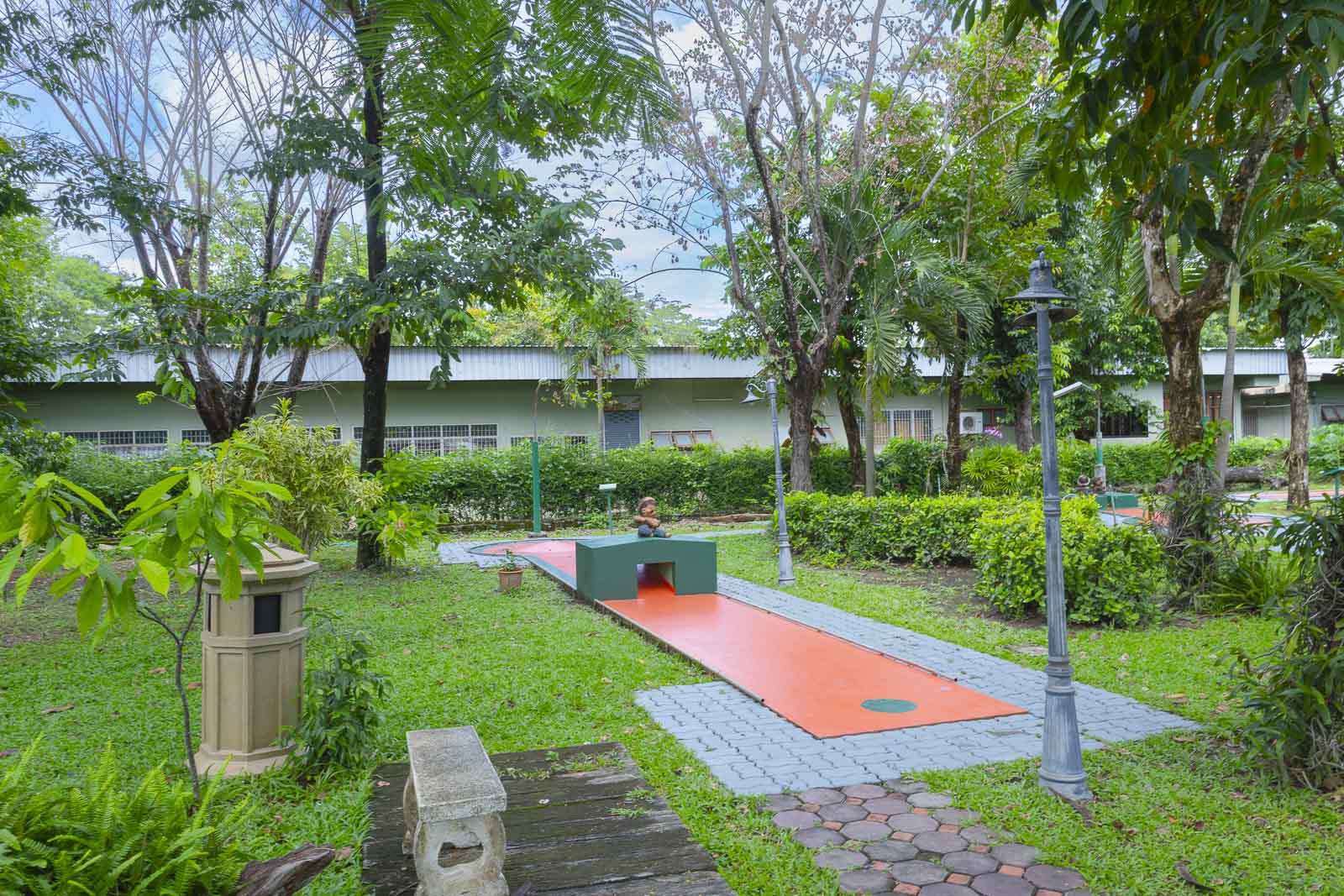 Minigolf lane surrounded by lawn and trees
