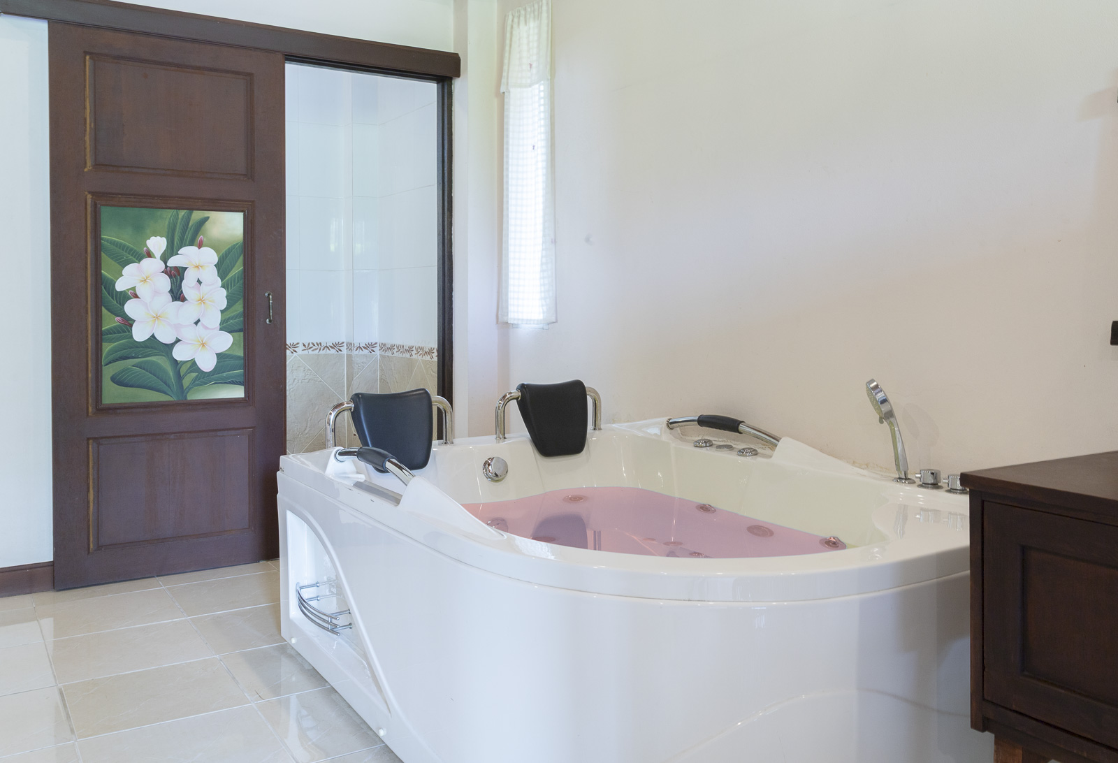 Corner whirlpool bath in a bright bungalow bathroom