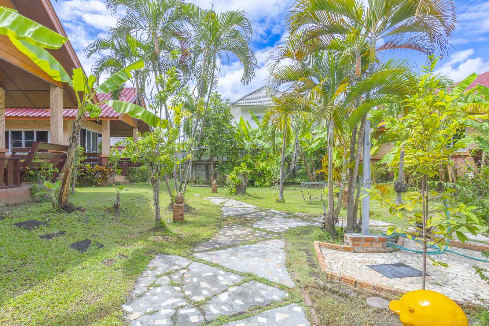 Stone path winding through the palm-filled resort garden