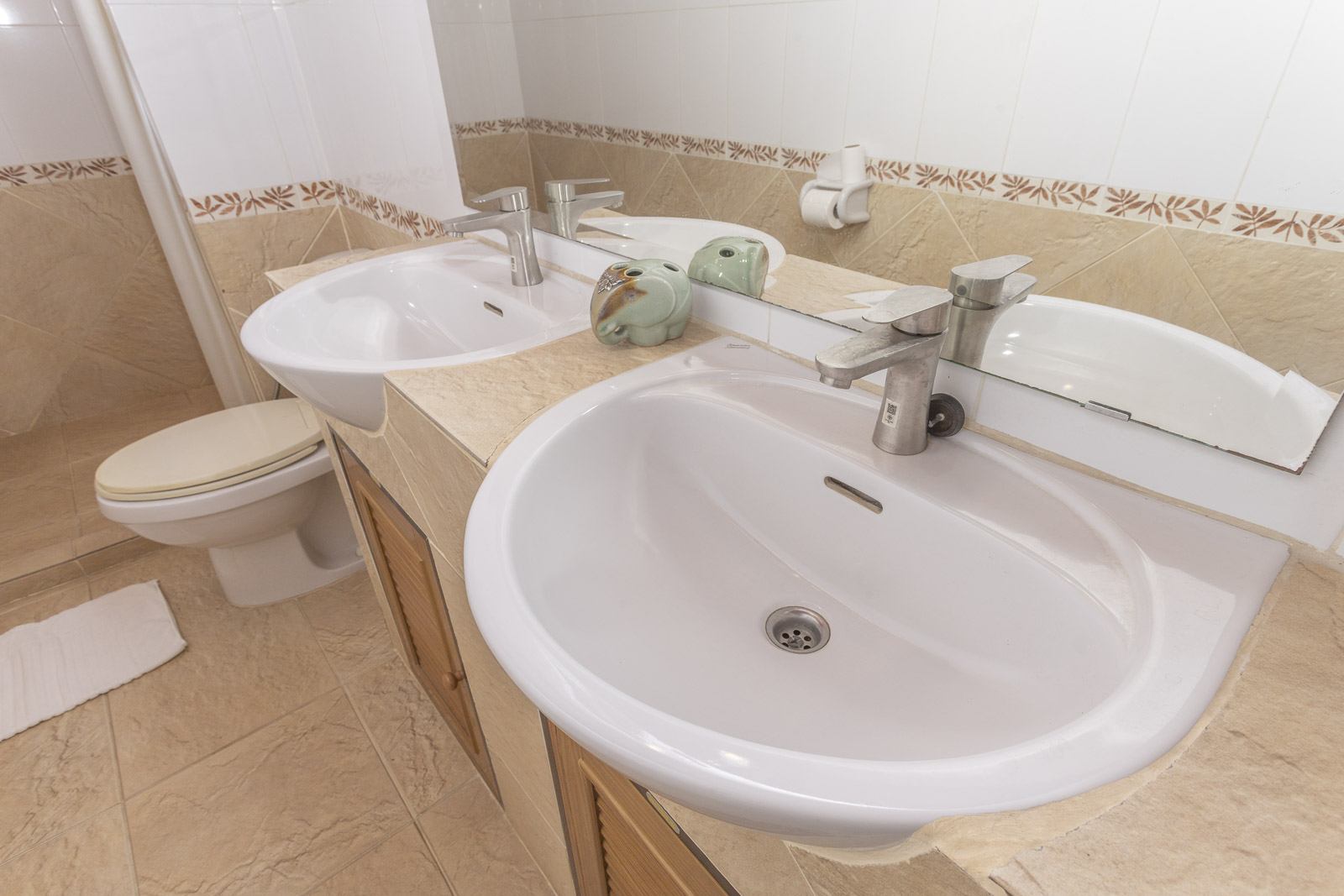 Bright bungalow bathroom with twin basins